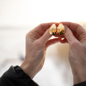 Kolczyki gruszki młotkowane na sztyfcie trzymane w rękach