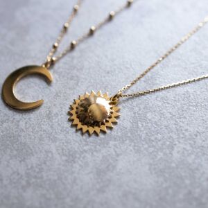 Zbliżenie na złotą zawieszkę słońce  ręcznie wykonana biżuteria handmade dla osób szukających polskiej, oryginalnej sztuki jubilerskiej